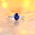 Load image into Gallery viewer, Sapphire and diamond engagement ring with an oval-cut center stone.
