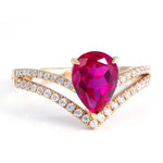 Load image into Gallery viewer, Vibrant pink pear-shaped gemstone ring with diamond-encrusted gold band.
