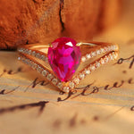 Load image into Gallery viewer, Gold ring with a pear-shaped pink gemstone and diamond accents.
