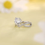 Load image into Gallery viewer, Diamond engagement ring with a twisted band featuring smaller diamonds.
