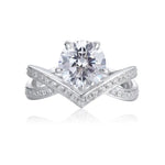 Load image into Gallery viewer, Diamond engagement ring with a prominent center stone and a chevron-shaped band adorned with smaller diamonds.
