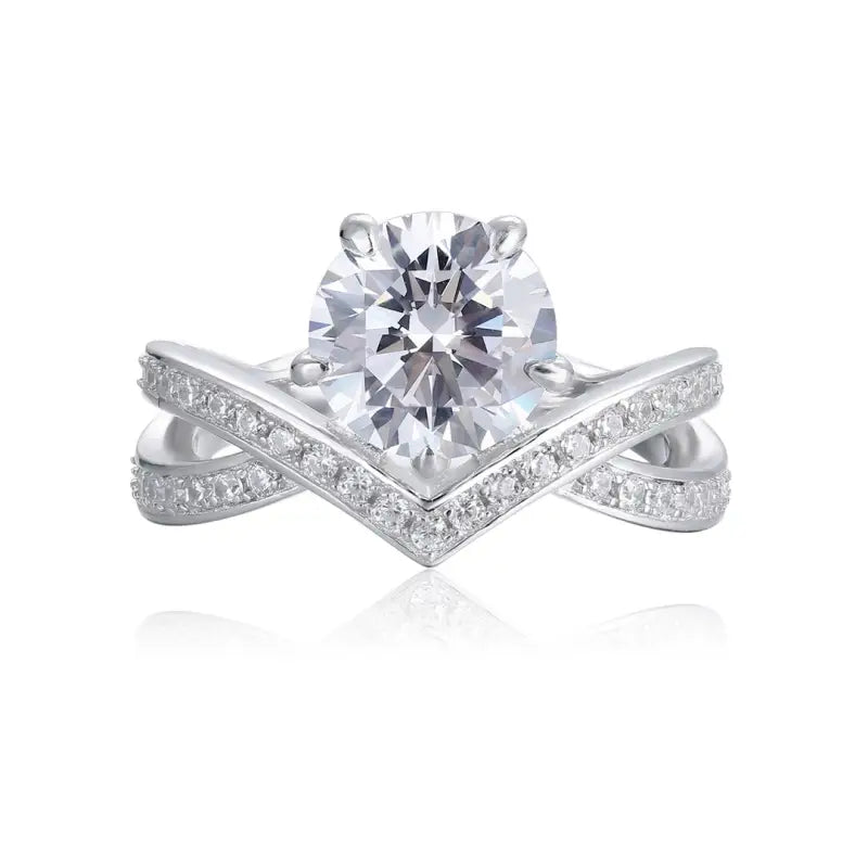 Diamond engagement ring with a prominent center stone and a chevron-shaped band adorned with smaller diamonds.