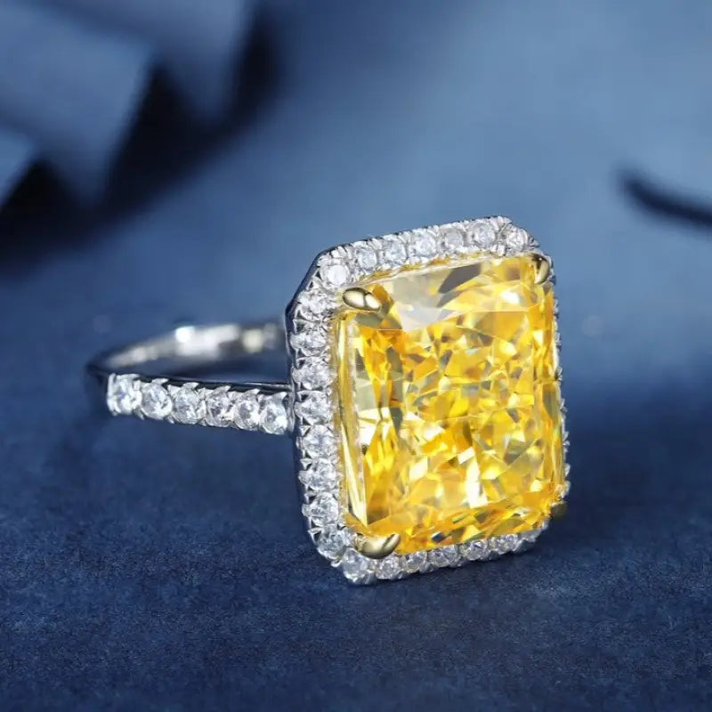 Dazzling yellow diamond ring with a halo of white diamonds set in a silver-toned band.