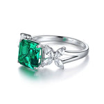 Load image into Gallery viewer, Silver ring featuring a square-cut emerald gemstone and diamond accents.
