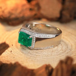 Load image into Gallery viewer, Emerald and diamond ring with a square-cut green gemstone set in a silver band.
