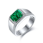 Load image into Gallery viewer, Silver ring featuring a prominent emerald-cut green gemstone surrounded by small diamonds.
