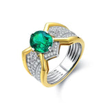 Load image into Gallery viewer, Elegant ring featuring a vibrant emerald gemstone set in gold and silver-toned metal with diamond accents.
