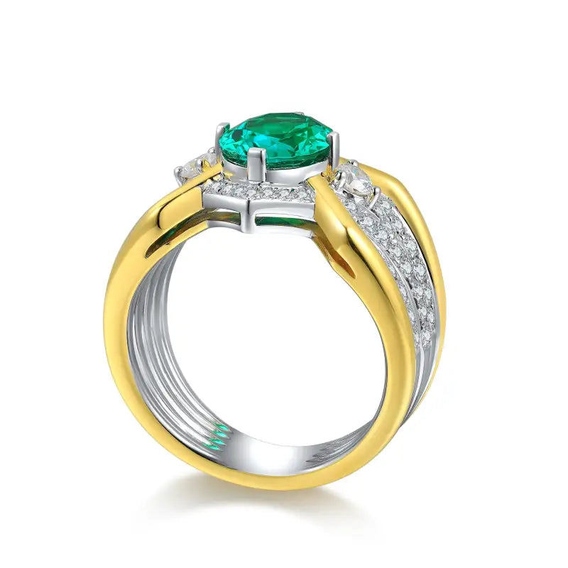 Two-tone gold and silver ring featuring a prominent emerald-cut green gemstone and diamond accents.