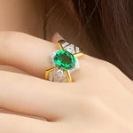 Load image into Gallery viewer, Ornate gold ring featuring a vibrant emerald-green gemstone surrounded by diamonds.
