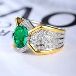 Load image into Gallery viewer, Ornate ring featuring a vibrant green gemstone surrounded by diamonds in a gold and silver setting.
