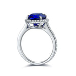 Load image into Gallery viewer, Elegant silver ring featuring a vibrant blue gemstone surrounded by small diamonds.
