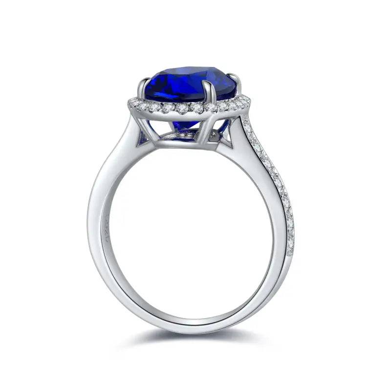 Elegant silver ring featuring a vibrant blue gemstone surrounded by small diamonds.