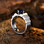 Load image into Gallery viewer, Silver ring with a deep blue gemstone and diamond accents on the band.
