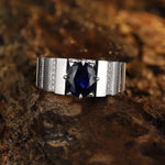 Load image into Gallery viewer, Silver ring with a deep blue gemstone and diamond accents.
