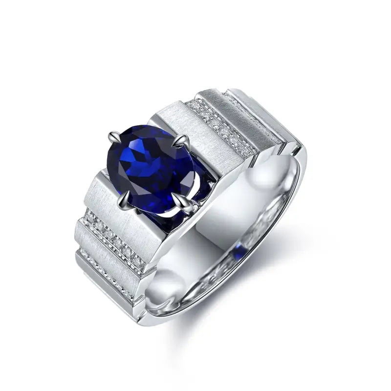 Silver ring with a prominent oval-cut blue gemstone and small diamond accents.