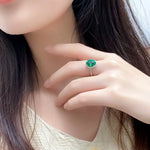 Load image into Gallery viewer, Emerald ring worn on a slender finger.
