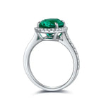 Load image into Gallery viewer, Elegant silver ring featuring a vibrant emerald-green gemstone surrounded by small diamonds.
