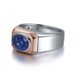 Load image into Gallery viewer, Two-tone ring featuring a deep blue oval gemstone set in a rose gold bezel on a silver band.
