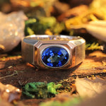 Load image into Gallery viewer, Silver ring with a prominent oval blue gemstone.
