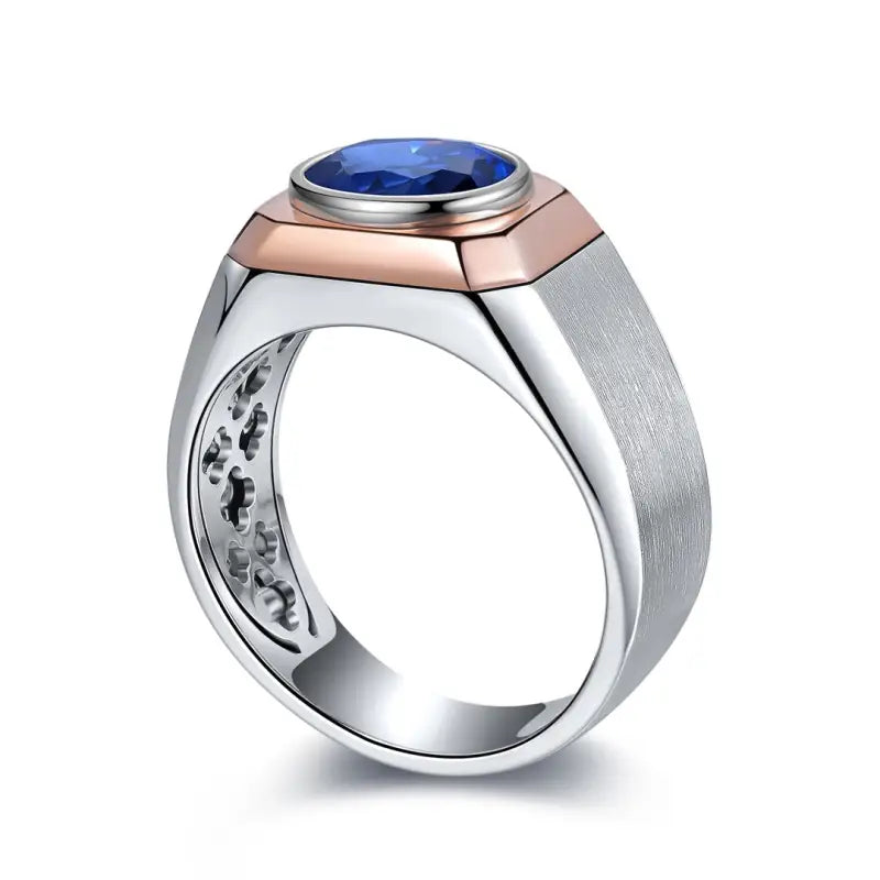 Men’s ring with a blue gemstone set in a mixed metal design.