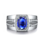 Load image into Gallery viewer, Silver ring featuring a vibrant blue oval gemstone surrounded by small diamonds.
