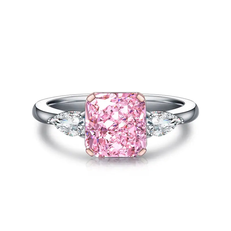 Pink diamond engagement ring with side accent stones on a silver band.