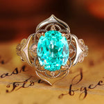 Load image into Gallery viewer, Ornate gold ring featuring a vibrant turquoise-colored gemstone in an intricate floral-inspired setting.
