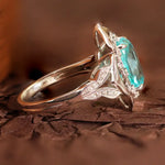 Load image into Gallery viewer, Elegant silver ring featuring a prominent turquoise gemstone and intricate butterfly-wing design.
