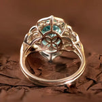 Load image into Gallery viewer, Ornate silver ring with a prominent blue-green gemstone in an intricate setting.
