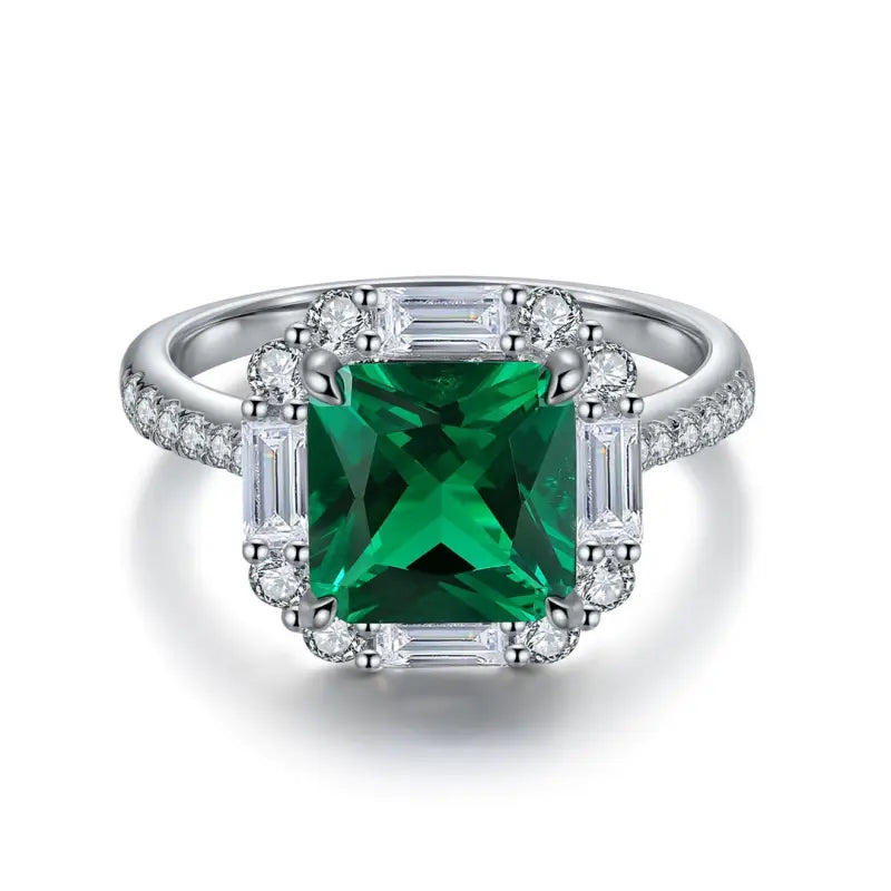 Emerald-cut green gemstone ring surrounded by diamonds in a white gold or platinum setting.