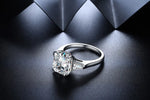 Load image into Gallery viewer, Diamond engagement ring with a prominent center stone and side accents.
