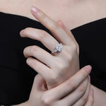 Load image into Gallery viewer, Diamond engagement ring on a woman’s finger.
