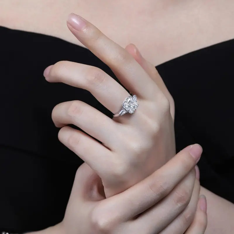 Diamond engagement ring on a woman’s finger.