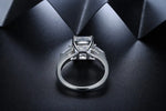 Load image into Gallery viewer, Diamond engagement ring with a square-cut center stone and side accents.
