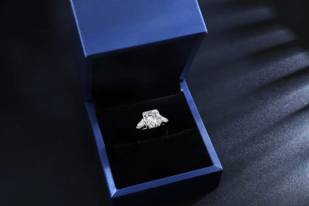 Diamond engagement ring in a blue velvet box.