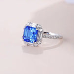 Load image into Gallery viewer, Sapphire and diamond engagement ring with a square-cut blue center stone.
