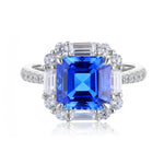 Load image into Gallery viewer, Sapphire and diamond engagement ring with a square-cut center stone.
