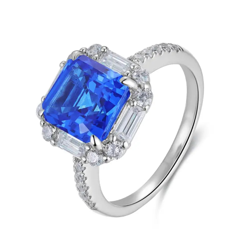 Sapphire and diamond engagement ring with a square-cut blue center stone.