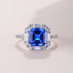 Load image into Gallery viewer, Sapphire and diamond engagement ring with a square-cut center stone.
