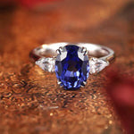 Load image into Gallery viewer, Sapphire and diamond engagement ring with an oval-cut center stone.
