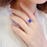 Load image into Gallery viewer, Sapphire ring with diamond accents on a delicate gold band.
