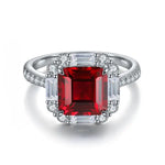 Load image into Gallery viewer, Ornate ring featuring a square-cut ruby surrounded by diamonds.
