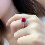 Load image into Gallery viewer, Square-cut ruby ring with diamond halo and band.
