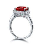 Load image into Gallery viewer, Silver ring with a prominent square-cut red gemstone surrounded by smaller clear stones.
