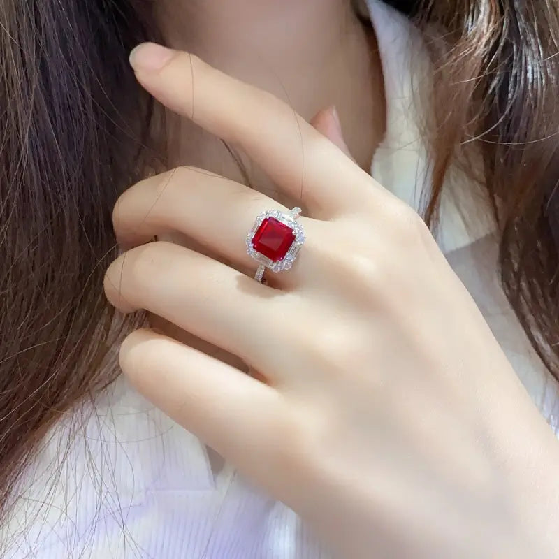 Ruby ring with a square-cut gemstone surrounded by smaller diamonds.