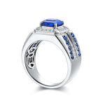 Load image into Gallery viewer, Silver ring with a prominent square-cut blue gemstone and smaller blue and clear stones along the band.
