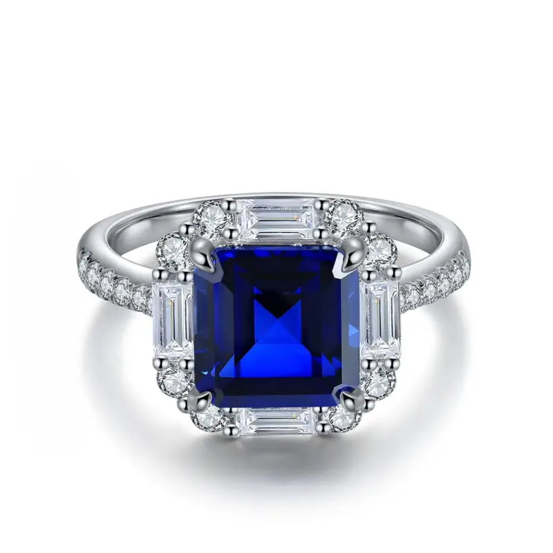 Sapphire and diamond engagement ring with a square-cut center stone.