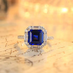 Load image into Gallery viewer, Sapphire and diamond ring with a square-cut center stone in a halo setting.
