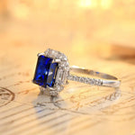 Load image into Gallery viewer, Sapphire and diamond engagement ring with a rectangular blue center stone.
