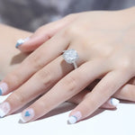 Load image into Gallery viewer, Diamond engagement ring on a woman’s hand with decorated nails.
